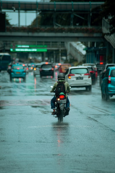 The man in black jacket during the day on the road to ride a motorcycle
